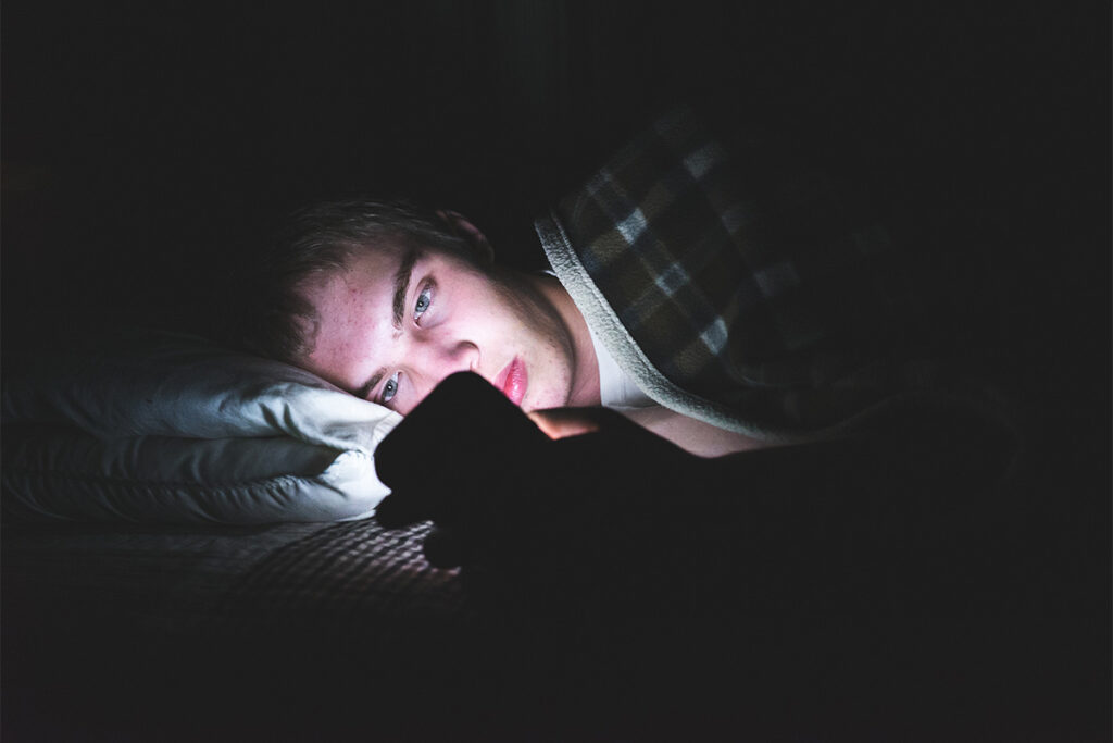 Teen boy reading about the effects of social media on teens